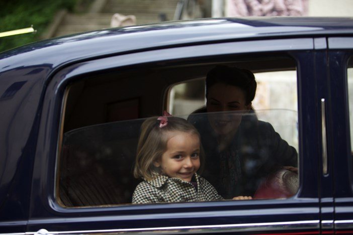 Margaux, la hija de Diego y Marianne, sonriendo desde el coche junto a su madre